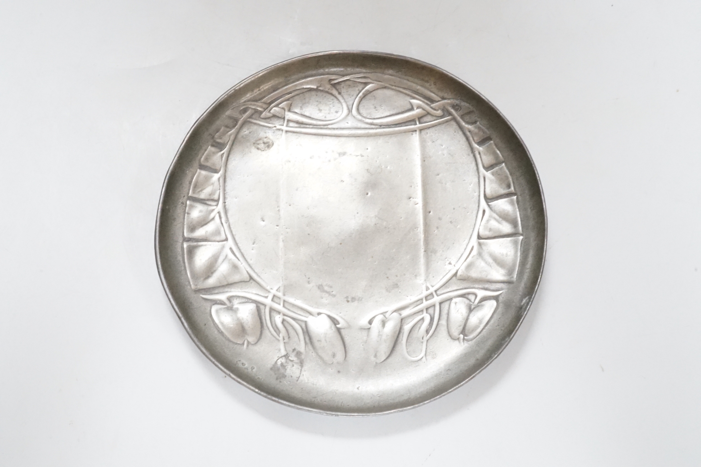 An Art Nouveau Liberty & Co pewter shallow circular dish, stamped on base and numbered 0231, 14cm diameter